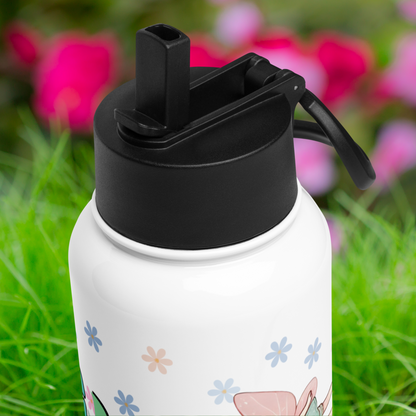 Top view of the plastic black lid on the tumbler. You see the drinking straw is flipped up and the channel it flips down into is visible.
