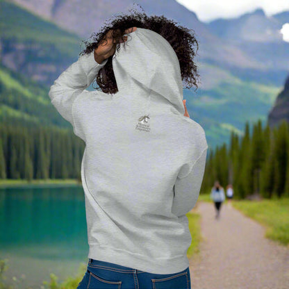 My Spirit Animal bear women's hoodie. Back view model sport grey hoodie.  Grizzly Bear paused in front of logs walking through the forest framed in a sunset. My Spirit Animal text at the top in white script.