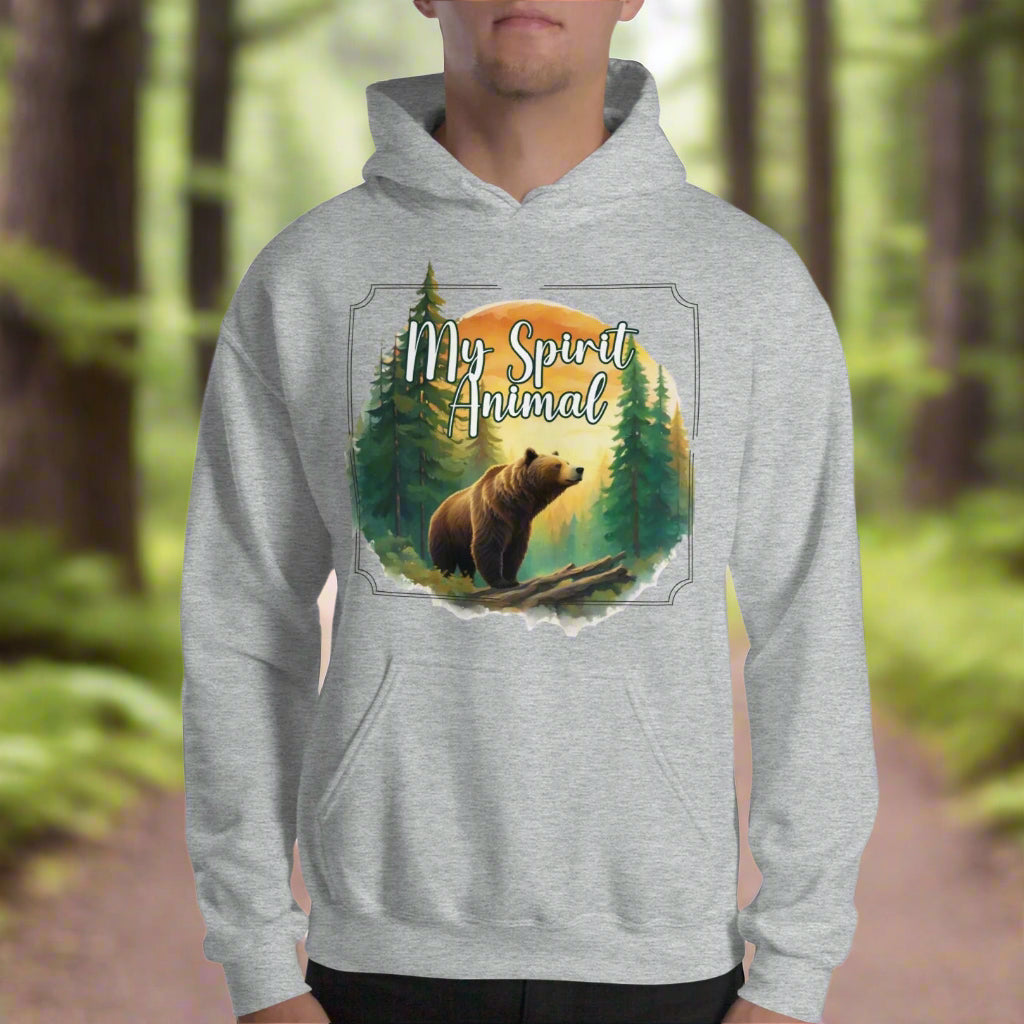 My Spirit Animal bear men's graphic hoodie. Front view sport grey hoodie.  Grizzly Bear paused in front of logs walking through the forest framed in a sunset. My Spirit Animal text at the top in white script. Mythical Accessories