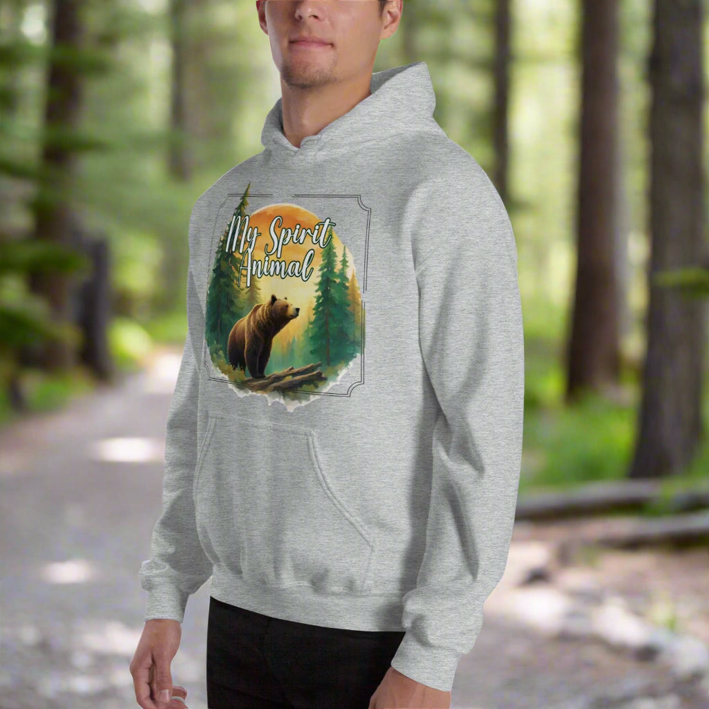 My Spirit Animal bear men's graphic hoodie. Front left view sport grey hoodie.  Grizzly Bear paused in front of logs walking through the forest framed in a sunset. My Spirit Animal text at the top in white script. Mythical Accessories