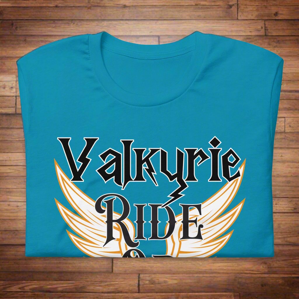 Aqua Front View Valkyrie Ride or Die, Men's Tshirt on a wooden counter. White wings edged in gold spread to either side of the shirt. Through the middle is the black text edged in white. Text reads Valkyrie Ride or Die