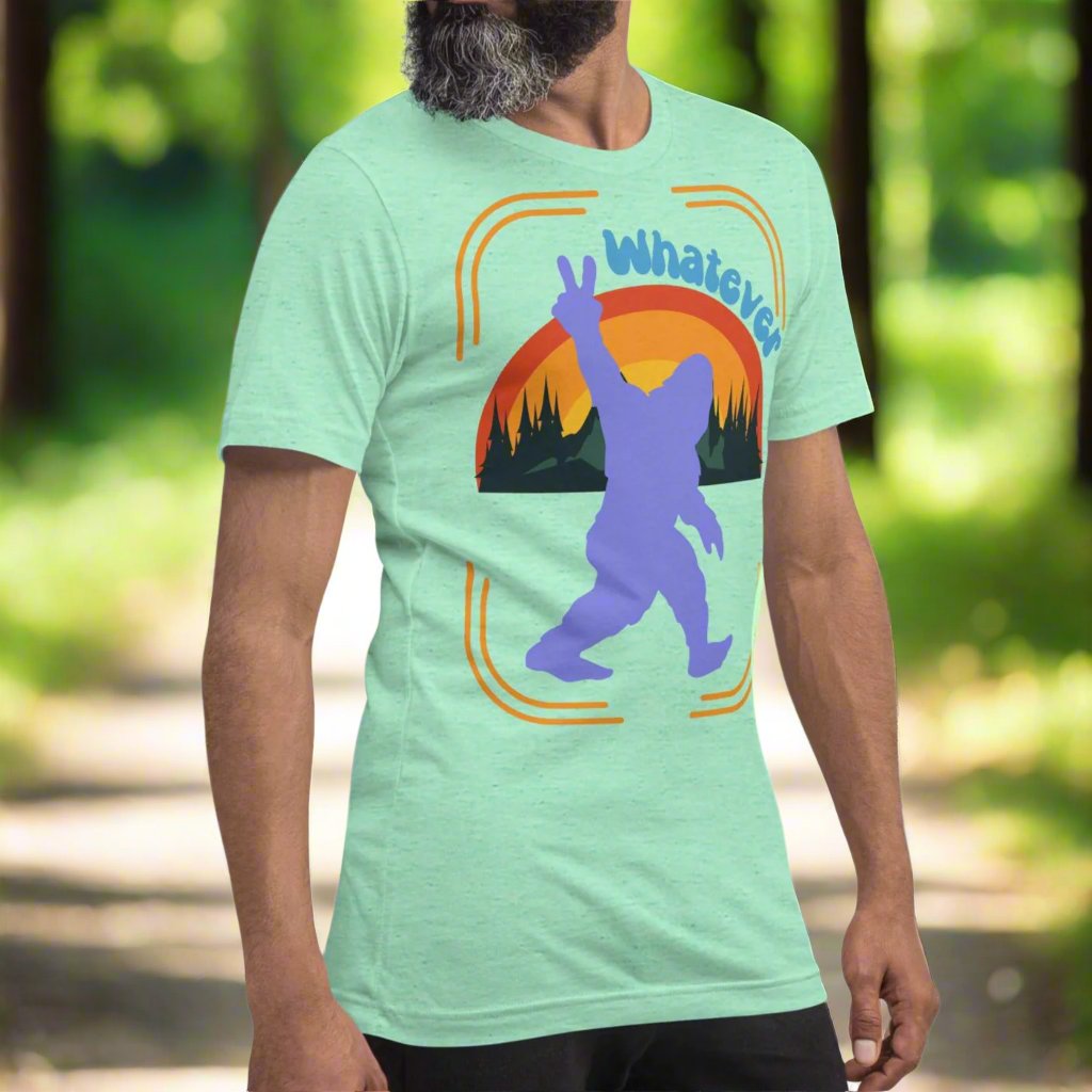 heather mint big foot men's shirt side front view. Purple big foot showing a peace sign against mountains, forest, and a rainbow. Above this is the text whatever.