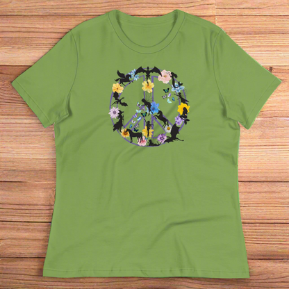 70s Vintage Peace Sign Women's leaf (green) T-Shirt Front View laying on wooden counter. Purple Peace sign filled in with dragons, mermaids, fairies, unicorns, pegasi, witches, flowers, and butterflies. 