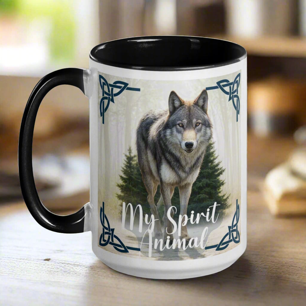 Wolf My Spirit Animal Ceramic Coffee Mug. Handle to he left with a black interior and handle. A grey wolf gazes at you from the forest bordered in Celtic knots. Timber Wolf Shamanic Totem Animal, Mythical Accessories Emporium.