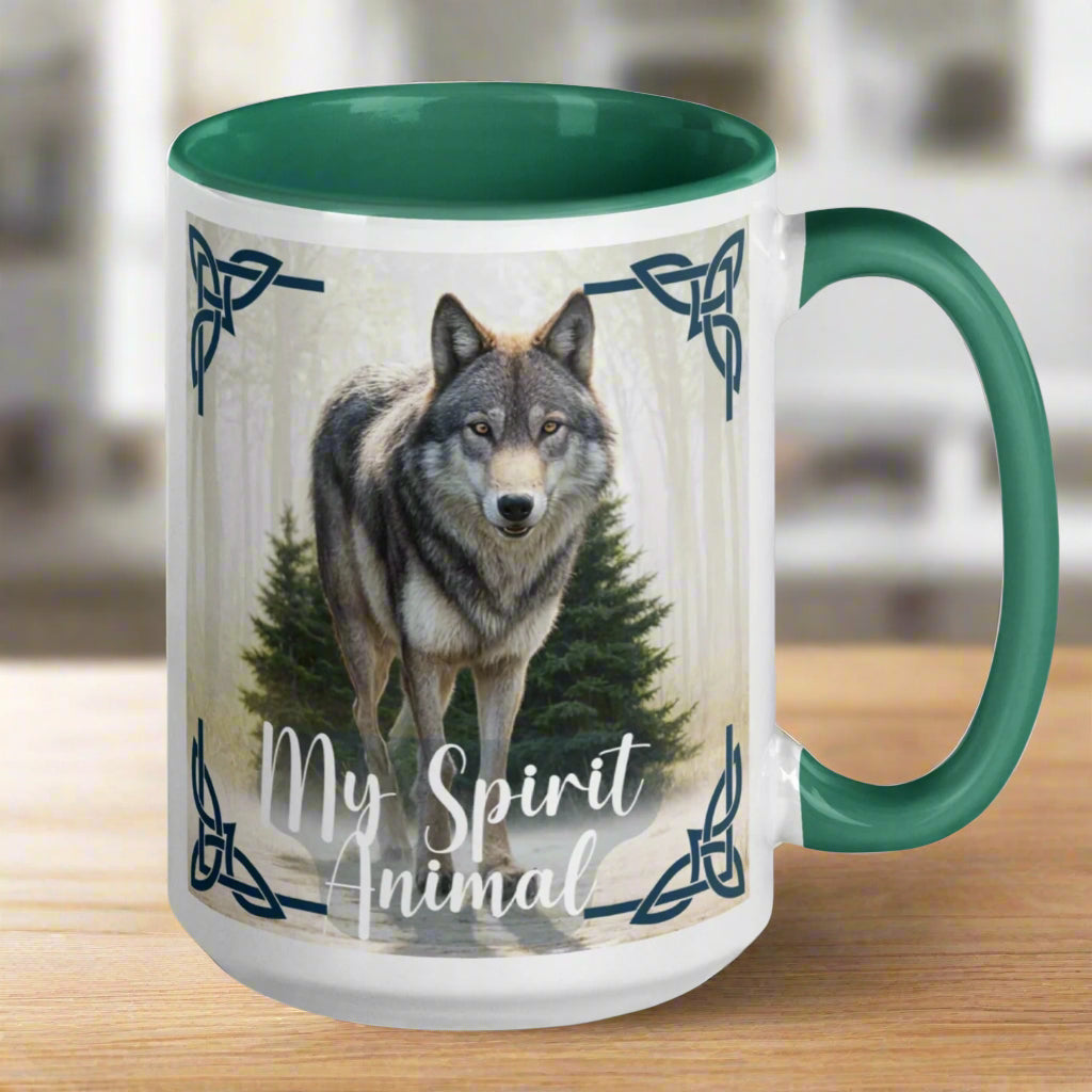 Wolf My Spirit Animal Ceramic Coffee Mug. Handle to he right with a green interior and handle. A grey wolf gazes at you from the forest bordered in Celtic knots. Timber Wolf Shamanic Totem Animal, Mythical Accessories Emporium.