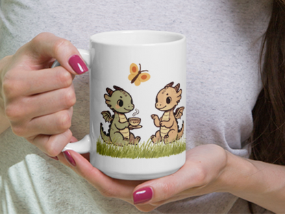 Woman holding dragon tea mug in her hands. Handle is to the left and you can see the two dragons having tea in the grass. 