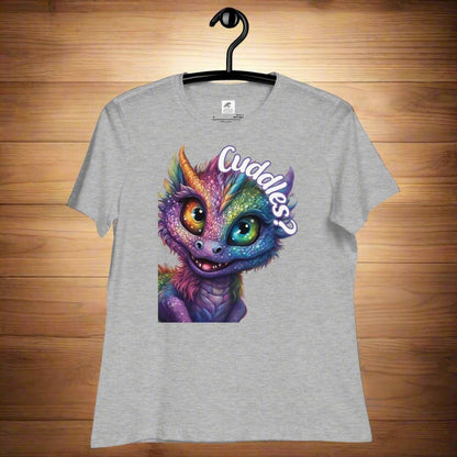 athletic Heather Grey Dragon Cuddles Front View Women's T-Shirt on a hanger. Whimsical purple iridescent  dragon looking up at the word Cuddles? above his head