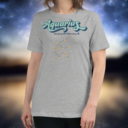 Woman in a athletic heather astrology Aquarius T-shirt facing forward. At the top in light blue is the word Aquarius outlined in deeper blue. Below this it says January 20- February 18. Under this is the Aquarius constellation with orange yellow stars connected by a black line. Astrology Zodiac Aquarius Woman's Tee
