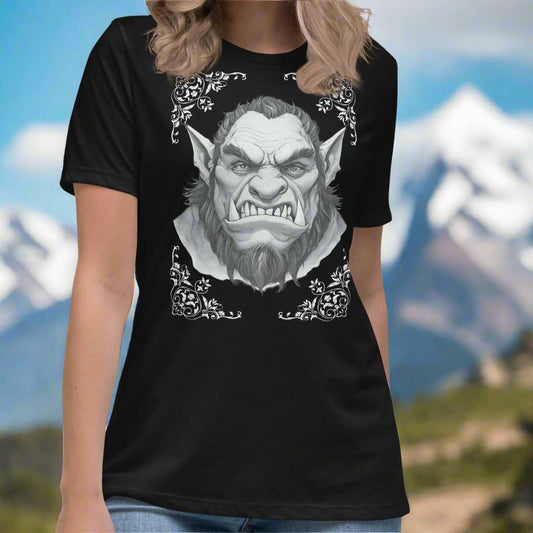 Orc Women's T-Shirt, black, front view. Flower corner borders in white frame a black and white image a fierce Orc. Bearded, tusk like teeth, and pointed ears of a deadly fae.