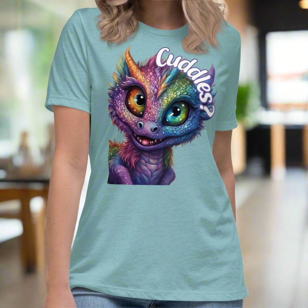 Heather Blue Lagoon Dragon Cuddles Front View Women's T-Shirt. Whimsical purple iridescent  dragon looking up at the word Cuddles? above his head