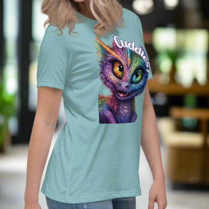 heather blue lagoon Dragon Cuddles right side View Women's T-Shirt. Whimsical purple iridescent  dragon looking up at the word Cuddles? above his head