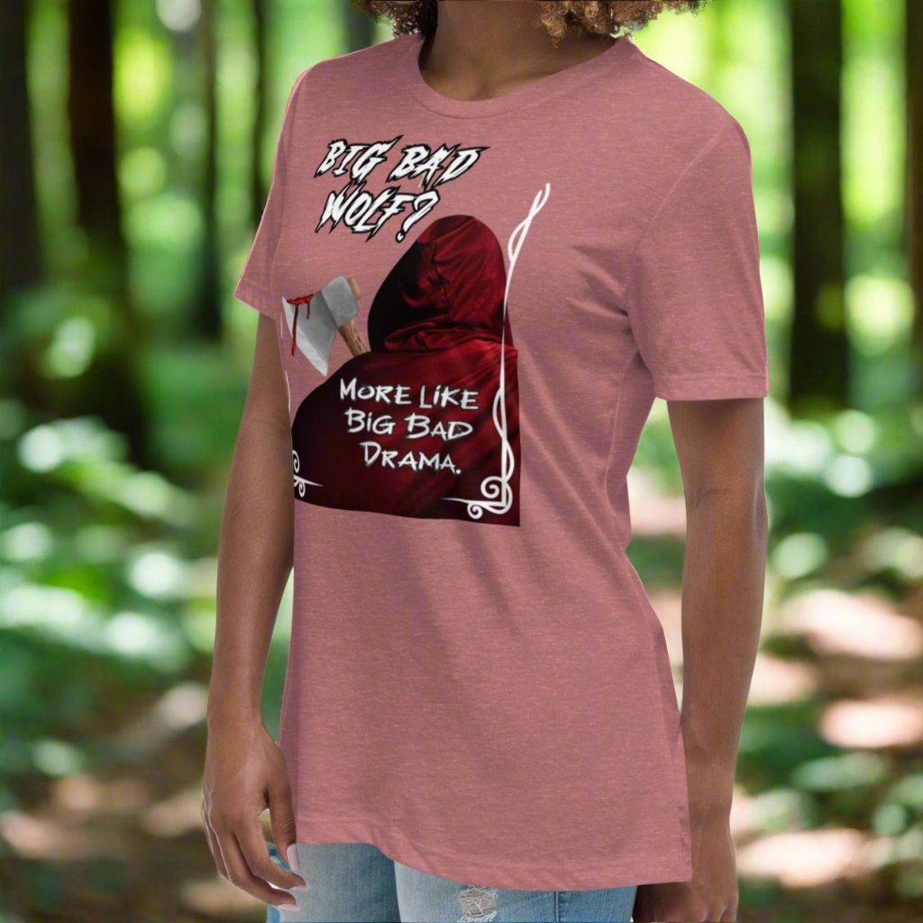 Heather Mauve Women's Graphic T-Shirt model left front view. Big Bad Wolf Little Red Riding Hood. Big Bad Wolf? More Like Big Bad Drama. Back of Red Riding Hood with hood pulled up, bloodied axe over shoulder.