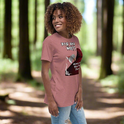 Heather Mauve Women's Graphic T-Shirt model right side view. Big Bad Wolf Little Red Riding Hood. Big Bad Wolf? More Like Big Bad Drama. Back of Red Riding Hood with hood pulled up, bloodied axe over shoulder.