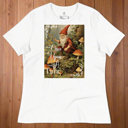 front view of women's relaxed graphic tee. Once Upon A Time classic vintage from the 1800s fairy tales. Gnome sitting in a forest surrounded by mushrooms.